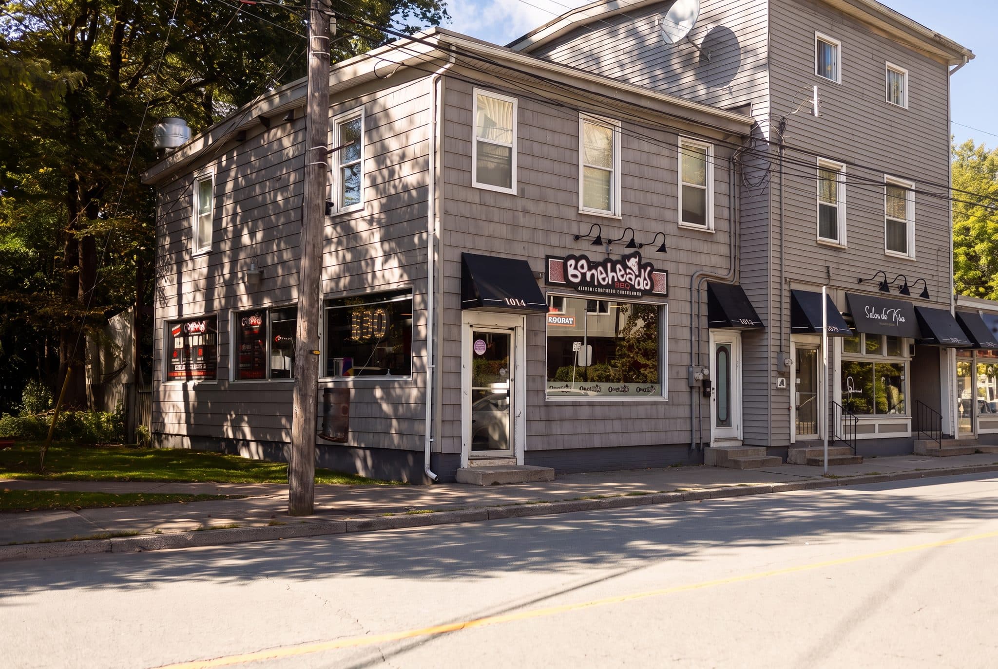 Boneheads BBQ on the corner of Barrington Street, the sign over the door and the BBQ letters lit in the window