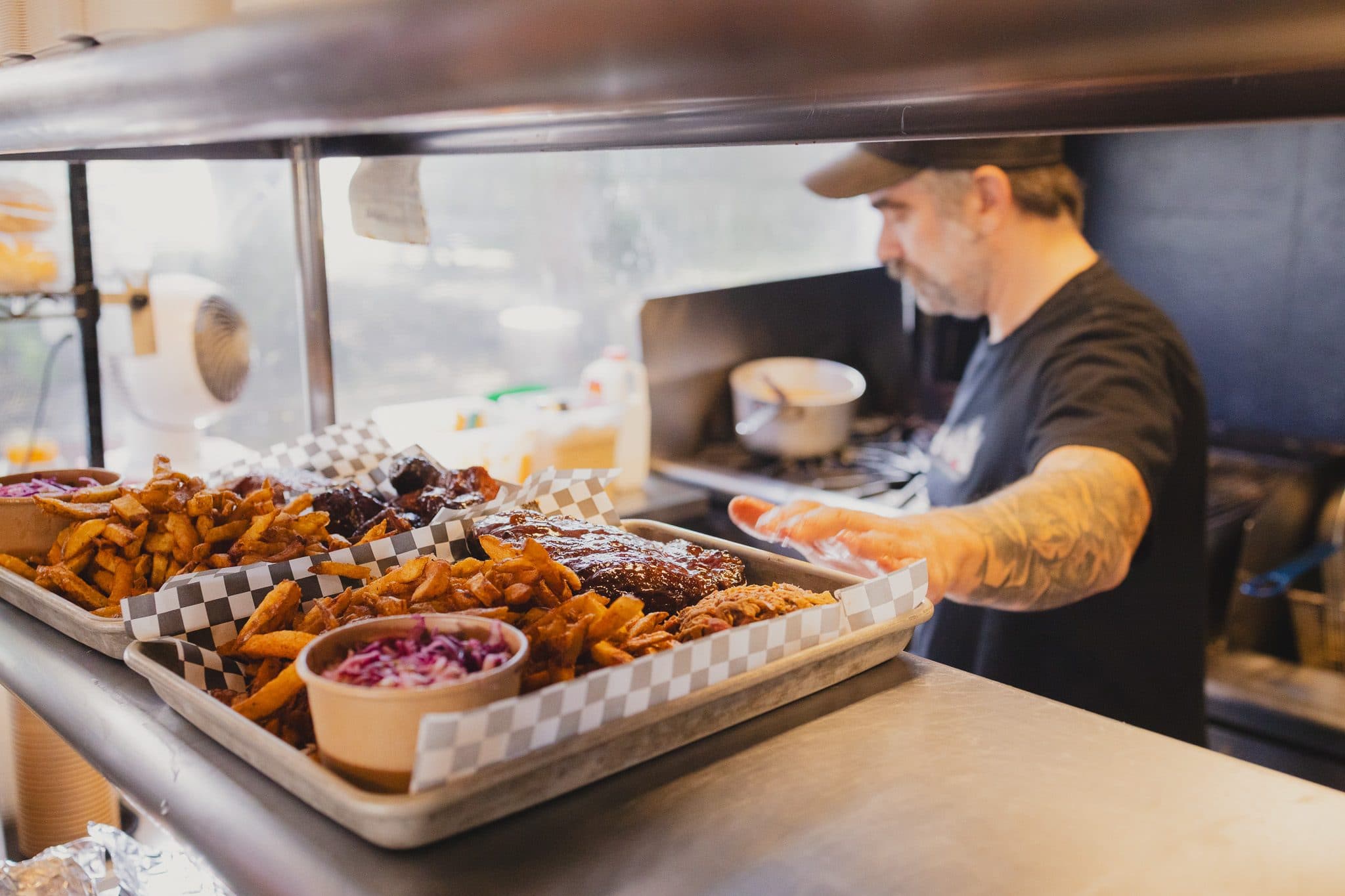 Trays being loaded at the Boneheads BBQ kitchen pass